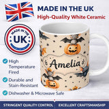 Personalized Custom Name Cute Halloween Bats Sitting on Pumpkins with Stars Beige Background 11oz Ceramic Coffee Tea Mug White Large Handle